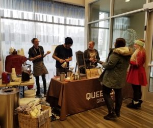 Queen City Grounds vendor table with customers